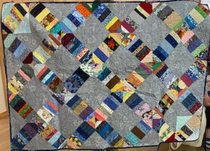 colorful scrappy quilt with gray background