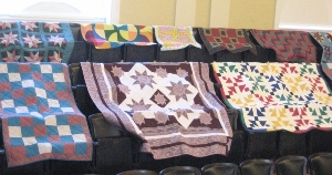 picture of benefit quilts displayed at our show